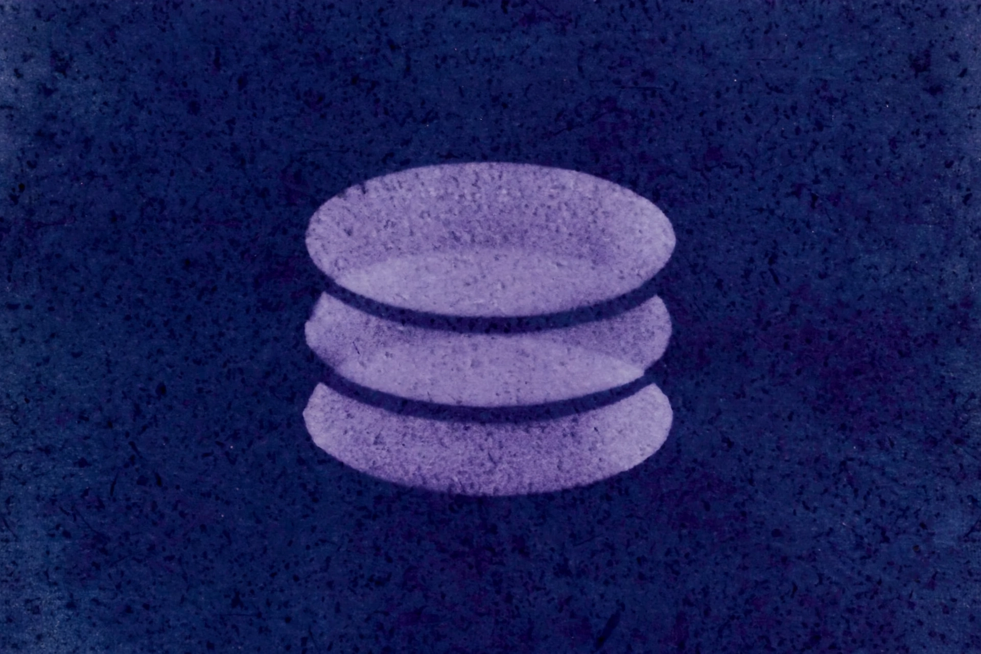 A photograph shows three stacked oval shapes in purple against a dark blue textured background.