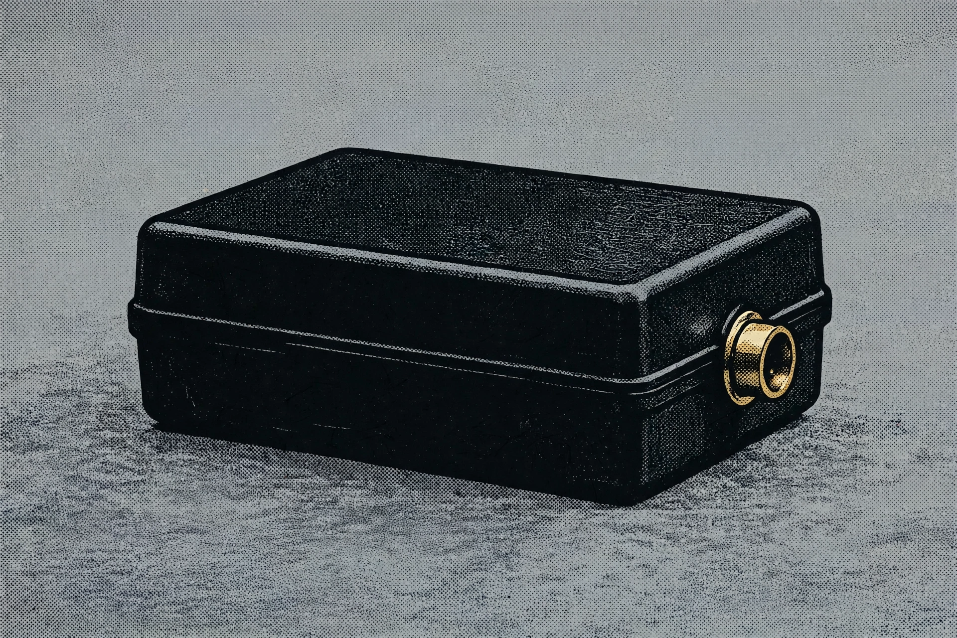 A black rectangular case with a brass fitting on the right side sits on a textured grey surface.