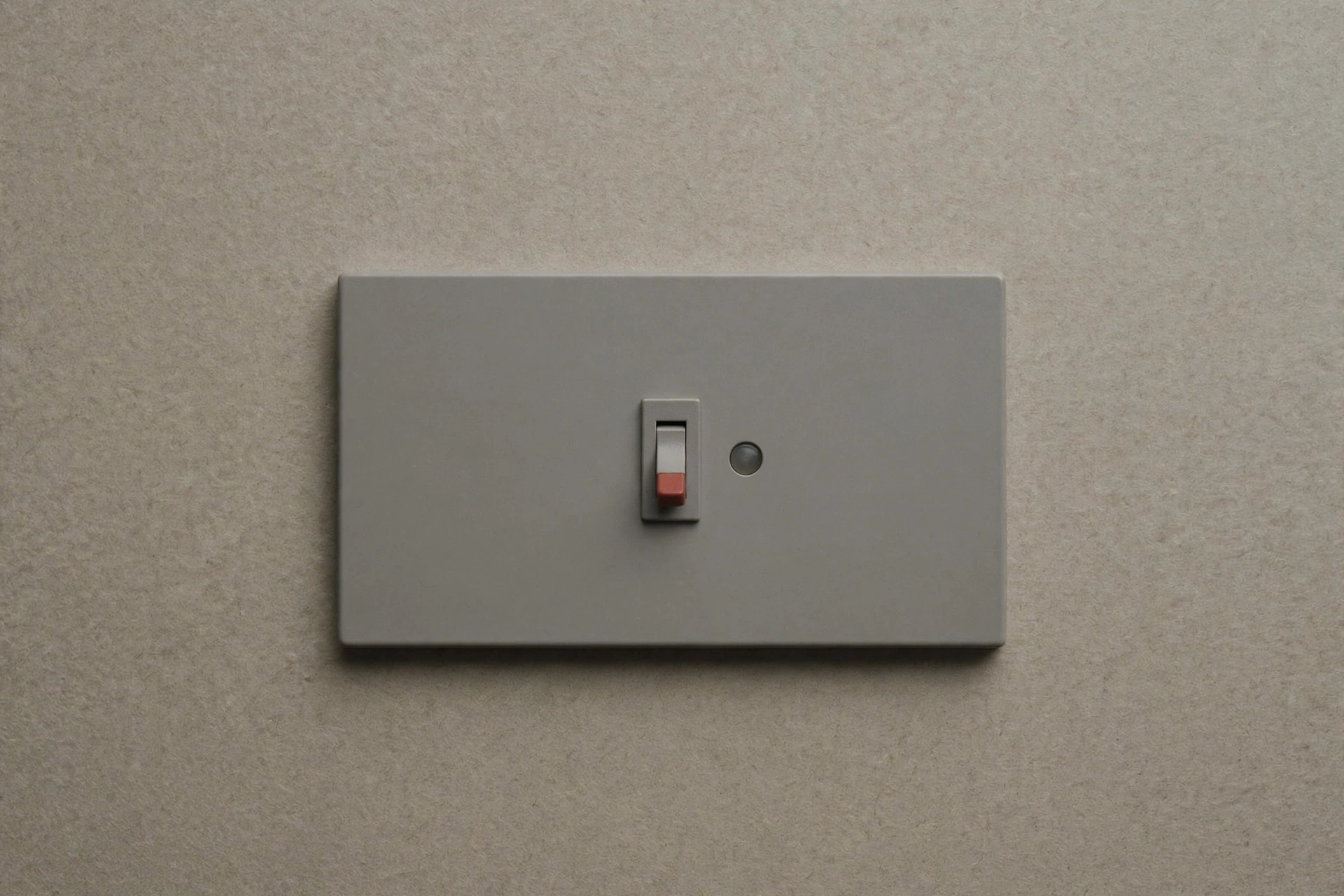 A photograph of a light switch on a wall.