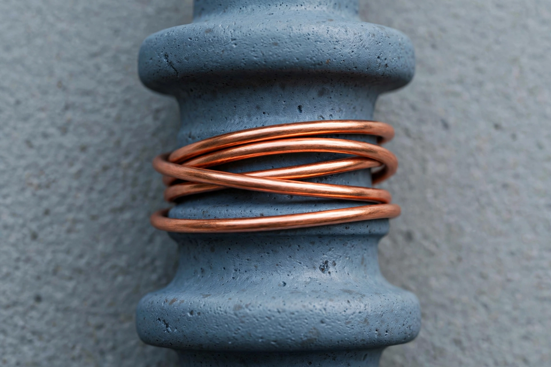 A photograph shows copper wire wrapped around a grey ceramic insulator.