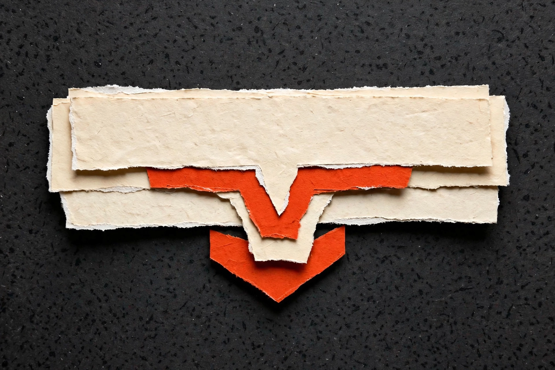 A collage of torn paper layered to create a V-shape against a dark background.